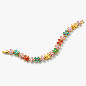 Gold floral bracelet with colorful enamel flowers and pink gemstone accents on white background