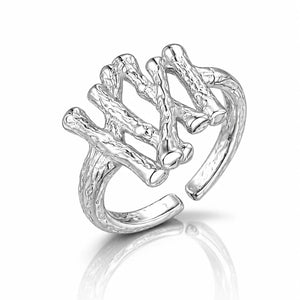 Silver ring with a leaf-like design on a white background