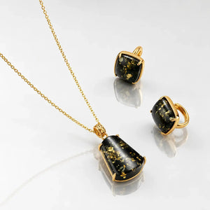 Jewelry set with pendant, ring, and earrings on a white background