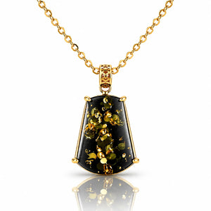 A gold pendant necklace featuring a faceted shield-shaped black stone with shimmering gold inclusions, suspended from a delicate gold chain on a white background with a soft reflection.