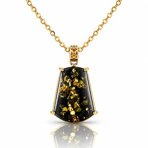 A gold pendant necklace featuring a faceted shield-shaped black stone with shimmering gold inclusions, suspended from a delicate gold chain on a white background with a soft reflection.