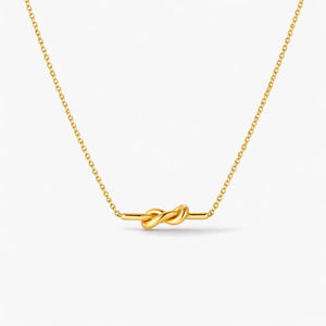 18K gold plated knot necklace with delicate chain on white background