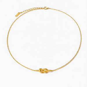 18K gold plated knot necklace with fine chain on white background