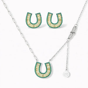 Horseshoe-shaped jewelry set with gold and green crystals, necklace and matching earrings.