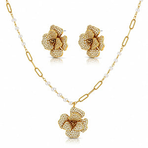 Gold-tone floral jewelry set with a pendant necklace, matching stud earrings, and a chain featuring small white pearls, shown on a clean white background.