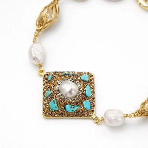 14K gold bracelet with baroque pearls, turquoise stones, and diamond accents on white background