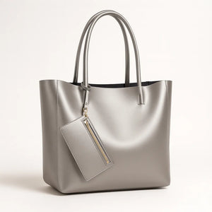 Elegant large-capacity tote bag made from genuine cowhide leather, bucket-style design with soft polyester-cotton lining, available in black, gold, and silver.
