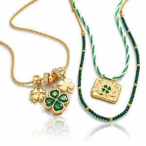 Two St. Patrick's Day themed necklaces displayed on a reflective white surface.