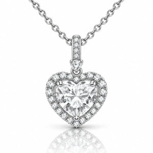 A heart-shaped diamond pendant necklace with a silver-toned halter setting and a matching chain, shown on a clean white background with a soft reflection below.