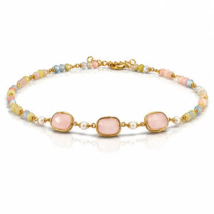 A gold-plated beaded bracelet featuring three large, rounded pale pink stones in bezel settings, accented by small white pearls and pastel-colored beads in pink, blue, yellow, and green.