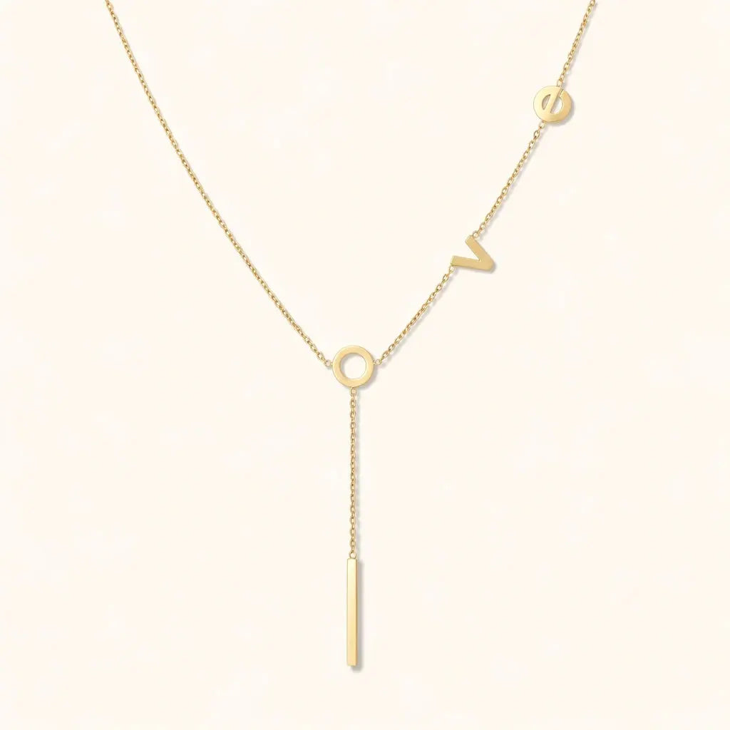 Gold necklace with a unique design on a white background