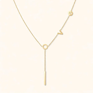 Gold necklace with a unique design on a white background