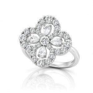 A silver-tone flower ring featuring multiple clear gemstones, including marquise and round cuts, set against a clean white background with a soft reflection below.