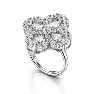 A silver four-petal flower ring featuring marquise-cut and round-cut clear gemstones, set against a clean white background with a soft reflection below.