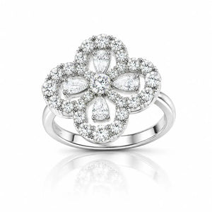 A silver-toned four-petal flower ring set with numerous clear diamonds, shown on a clean white background with a soft reflection below.