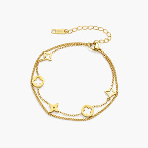 18K gold plated double chain bracelet with star and floral charms on white background