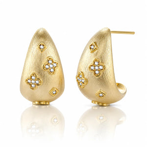 Gold earrings with floral designs on a white background