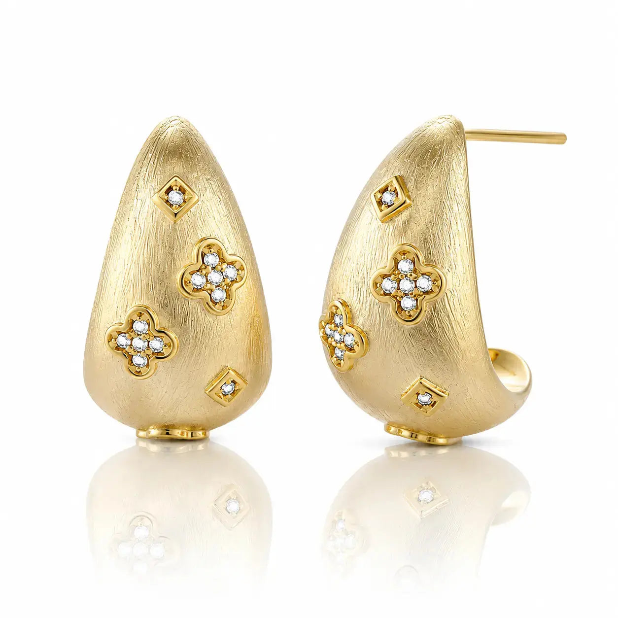 Gold earrings with floral designs on a white background