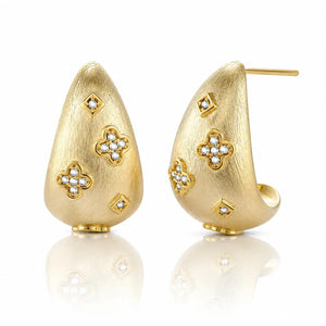 Gold earrings with floral designs on a white background