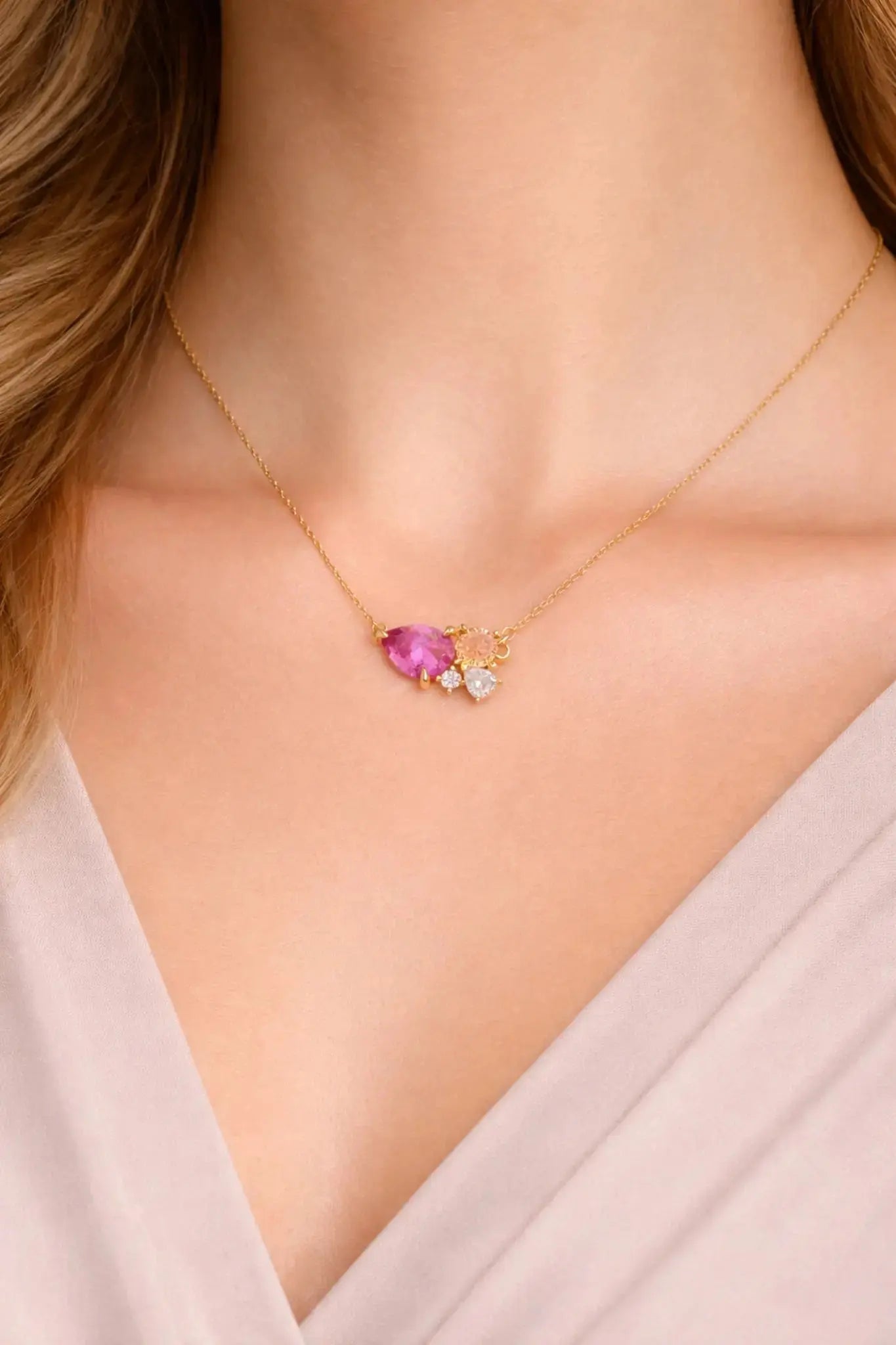 Necklace with a pink gemstone worn by a person
