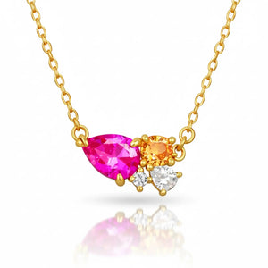 Gold necklace with pink, orange, and clear gemstones on a white background