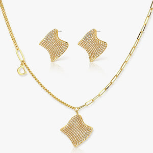 Gold necklace and earrings set on a white background