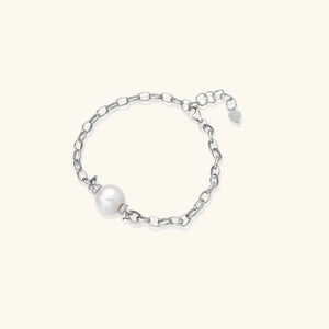 Silver bracelet with a single pearl on a white background