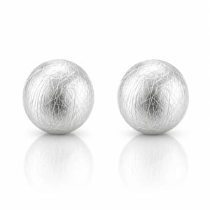 A pair of spherical silver earrings with a textured, fibrous hair-like surface, displayed on a clean white background with soft reflections below.