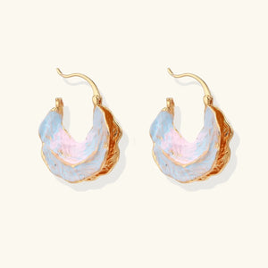 Gold hoop earrings with pastel-colored stones on a white background