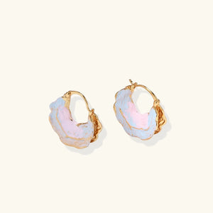 Gold hoop earrings with pastel-colored stones on a white background