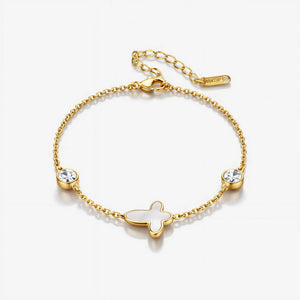 Gold bracelet with butterfly charm and crystals on a white background
