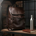 MetroCraft unisex PU leather laptop backpack in Black or Brown, minimalist design, 12×35×40 cm, lightweight 0.8 kg.