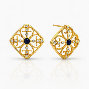 Gold earrings with black gemstones on a white background