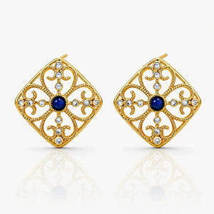 Gold earrings with blue gemstones on a white background