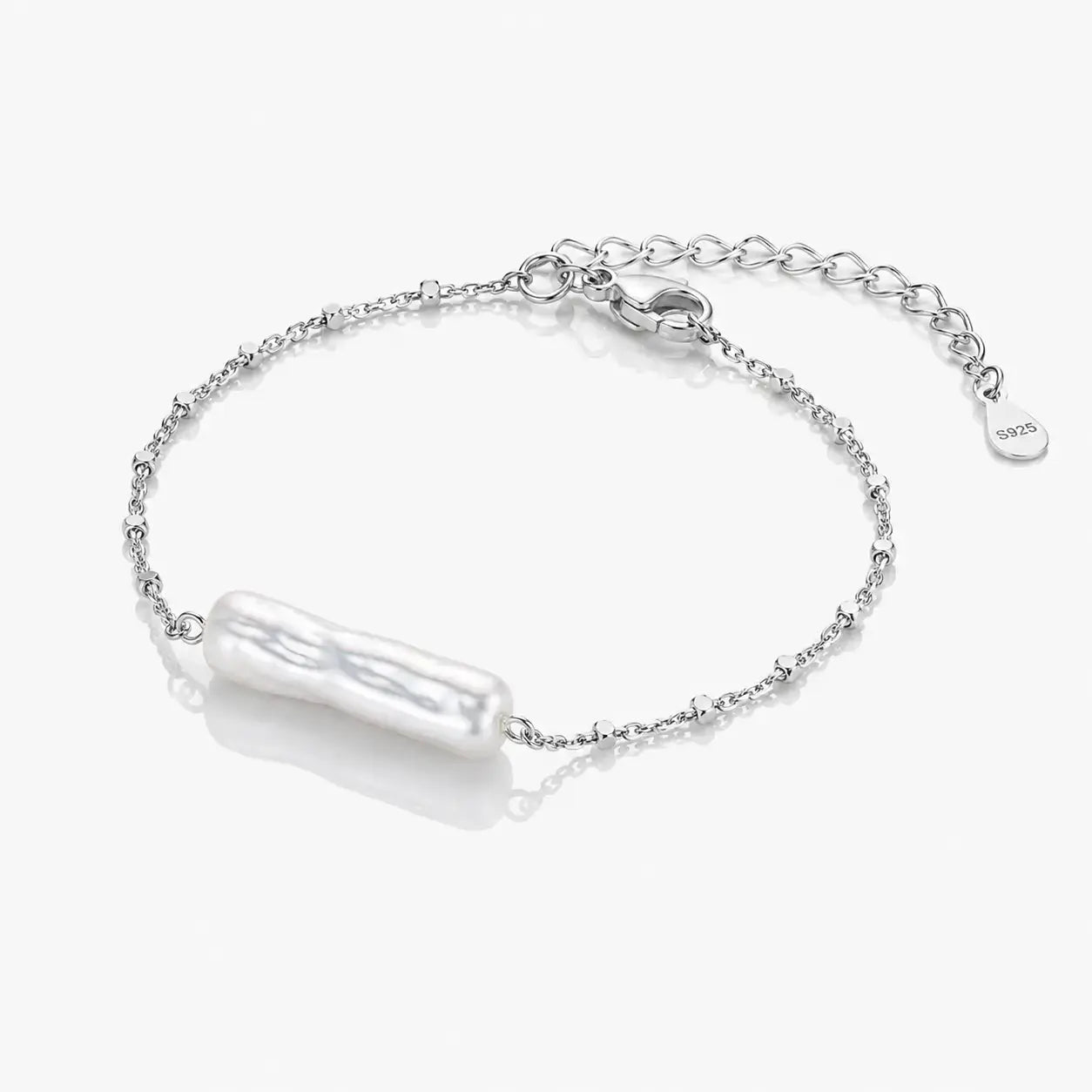 Silver bracelet with a pearl-like charm on a white background