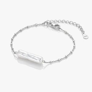 Silver bracelet with a pearl-like charm on a white background