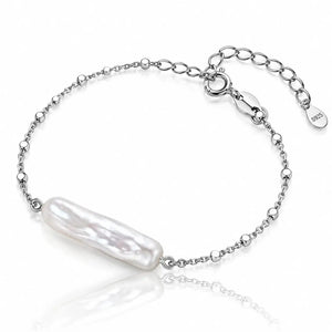 A silver chain bracelet featuring a large, lustrous baroque pearl pendant, displayed on a clean white background with a soft reflection.