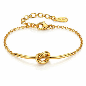 A gold-plated bracelet featuring a central knotted bar design, a classic lobster clasp, and an adjustable link chain extender with a '18K GP' hallmark tag, shown on a clean white background.