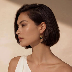 Woman wearing 18K gold plated sterling silver earrings with black agate drops