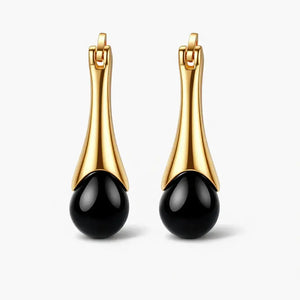 Pair of 18K gold plated sterling silver earrings with black agate drop design on white background