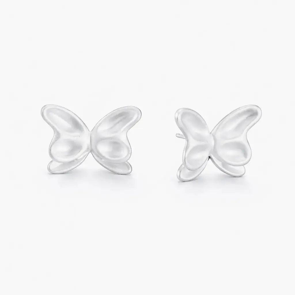 Butterfly-shaped silver earrings on a white background