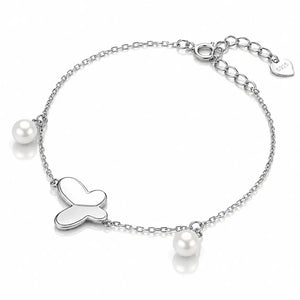 A silver chain bracelet featuring a central heart-shaped charm, two small white pearls, and a heart-shaped brand tag engraved with 'SOL' on a clean white background.