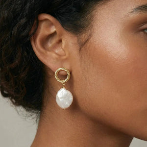Gold vermeil drop earring with large baroque pearl on model's ear