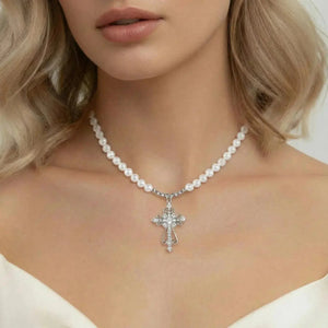 White gold pearl necklace with cross pendant on woman's neck, elegant jewelry style