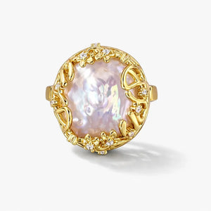 14K gold ring with large baroque pearl and floral diamond accents on a white background