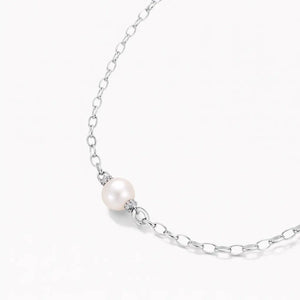 Silver chain necklace with single white pearl accent on white background