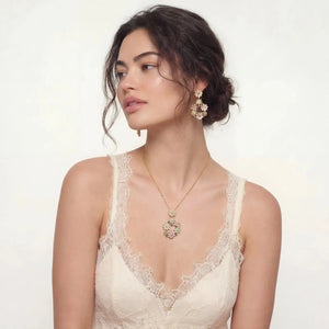 Woman wearing floral 14K gold plated CZ petal wreath necklace and earrings set