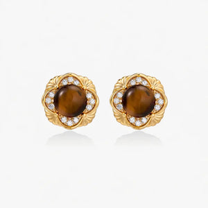 Pair of 18K gold stud earrings with round tiger eye centers and diamond accents on white background
