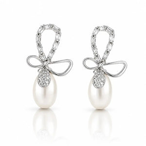 A pair of silver-tone drop earrings featuring a bow-shaped top set with clear pavé stones and a large white pearl dangling below, shown on a clean white background with soft reflections.