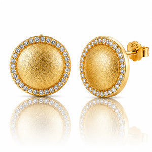 A pair of gold dome stud earrings with a halo of small clear stones, shown on a white background with a soft reflection below. One earring is facing forward, showing the textured gold center and the side post with a '925' sterling silver mark, while the other is turned sideways.